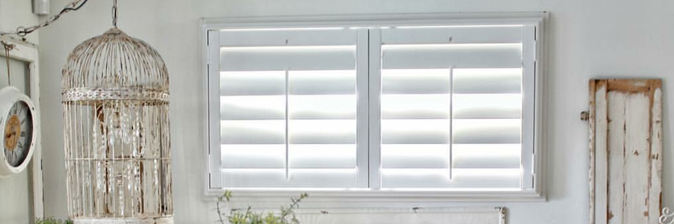 White Polywood shutters in a small living room area